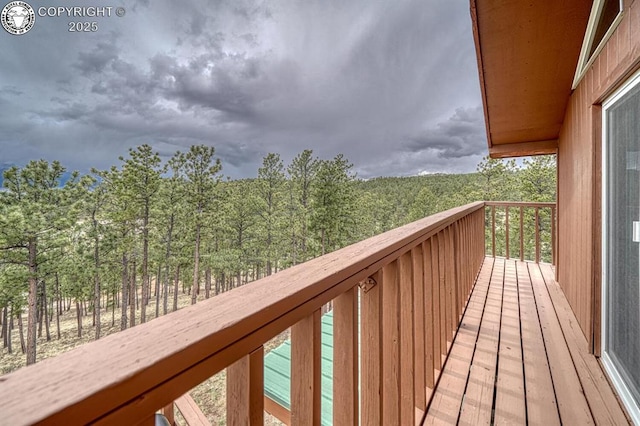 136 Beneaton Ln, Westcliffe, CO 81252 - wooden terrace featuring a wooded view