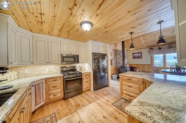 136 Beneaton Ln, Westcliffe, CO 81252 - kitchen with gas stove, stainless steel microwave, black refrigerator with ice dispenser, wooden ceiling, and wooden walls
