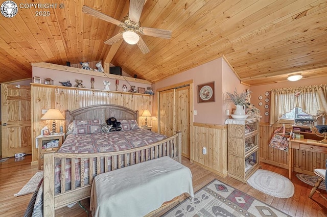 136 Beneaton Ln, Westcliffe, CO 81252 - bedroom featuring wainscoting, wood ceiling, wood walls, wood-type flooring, and a closet