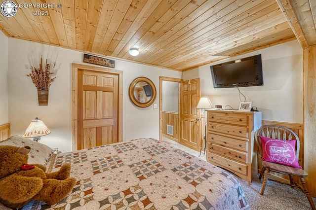 136 Beneaton Ln, Westcliffe, CO 81252 - bedroom with wood ceiling, carpet flooring, and a wainscoted wall