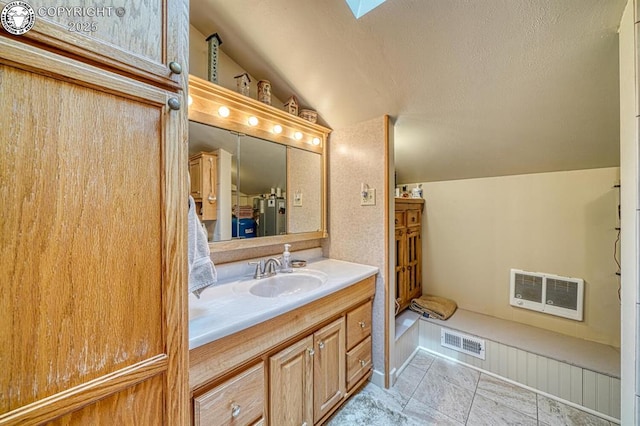 136 Beneaton Ln, Westcliffe, CO 81252 - bathroom with lofted ceiling, vanity, a skylight, a textured ceiling, and heating unit