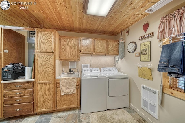 136 Beneaton Ln, Westcliffe, CO 81252 - washroom featuring separate washer and dryer, cabinet space, stone tile floors, wooden ceiling, and heating unit