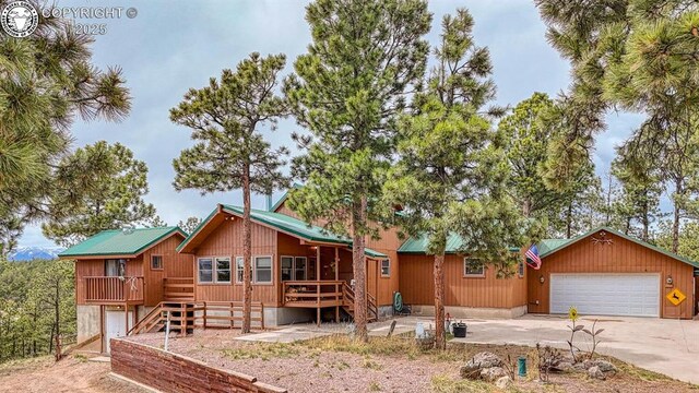 136 Beneaton Ln, Westcliffe, CO 81252 - chalet / cabin featuring driveway, a deck, and a garage