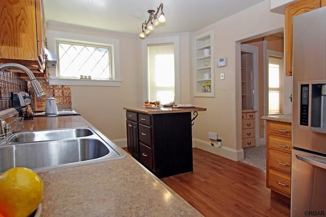 kitchen with fridge, sink, and hardwood / wood-style flooring