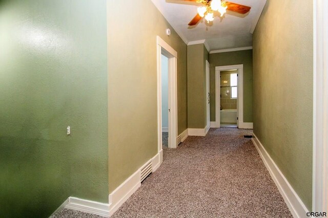 hall featuring ornamental molding and carpet floors