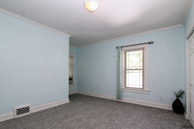 unfurnished room with ornamental molding and carpet flooring