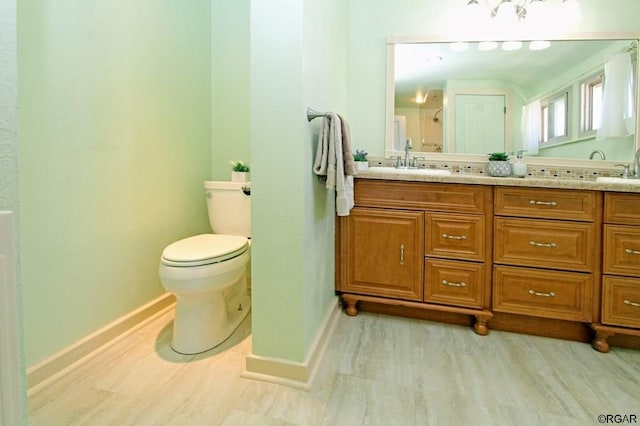 bathroom featuring hardwood / wood-style flooring, vanity, and toilet