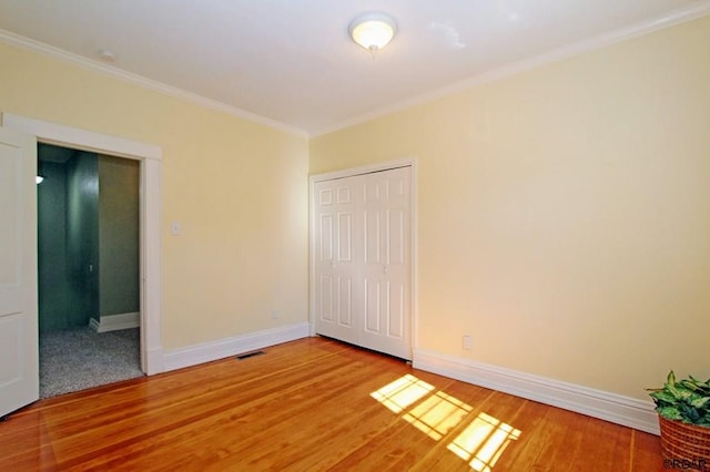 spare room with hardwood / wood-style flooring and ornamental molding