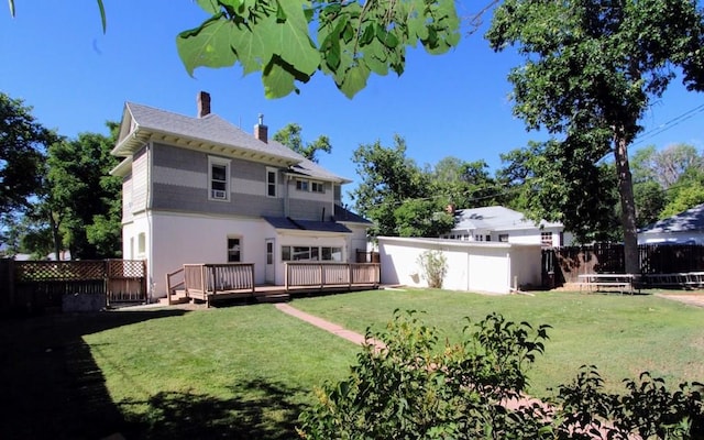 back of house with a yard and a deck