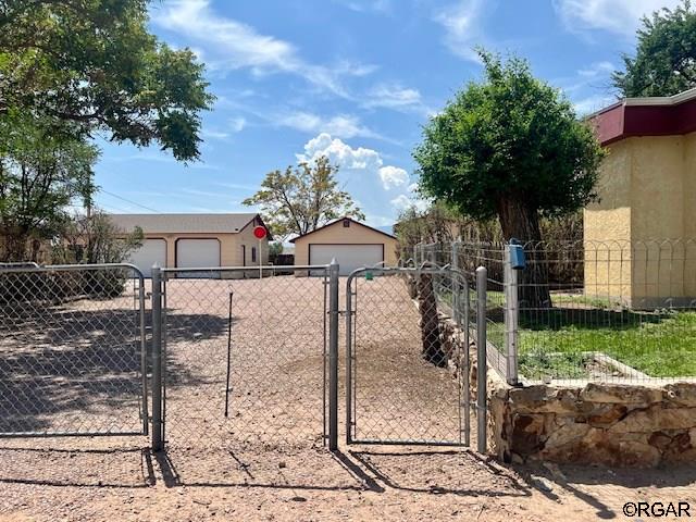 view of front of home with a garage and an outdoor structure