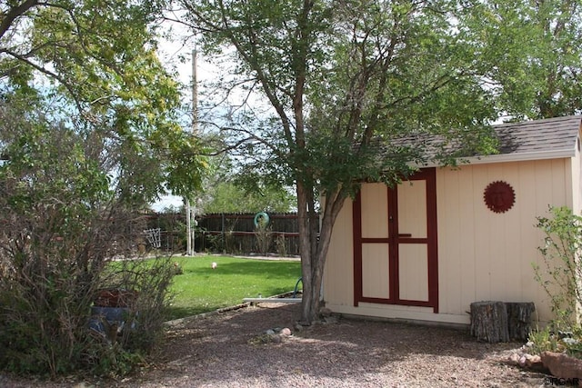 view of outbuilding with a yard