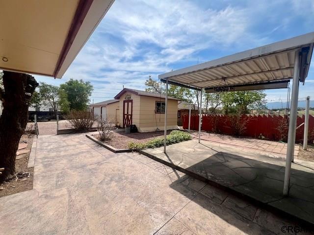 view of patio / terrace featuring a storage unit