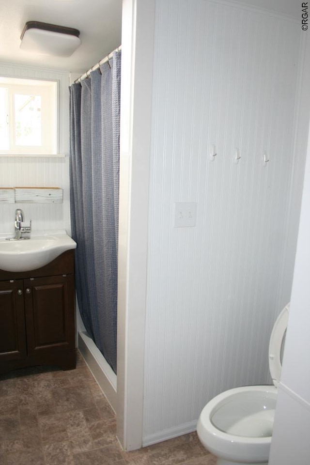 bathroom with vanity, toilet, and walk in shower