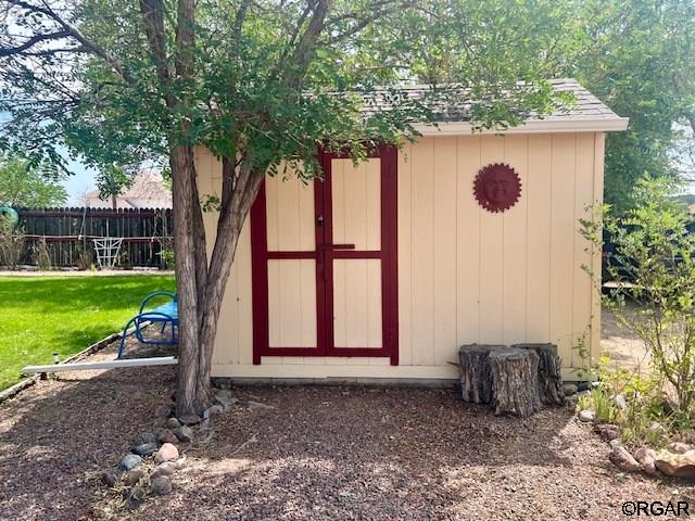 view of outbuilding with a lawn