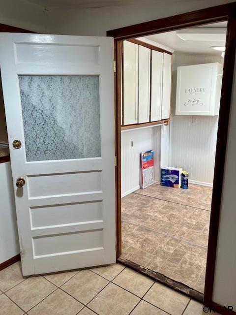 doorway to outside with light tile patterned floors