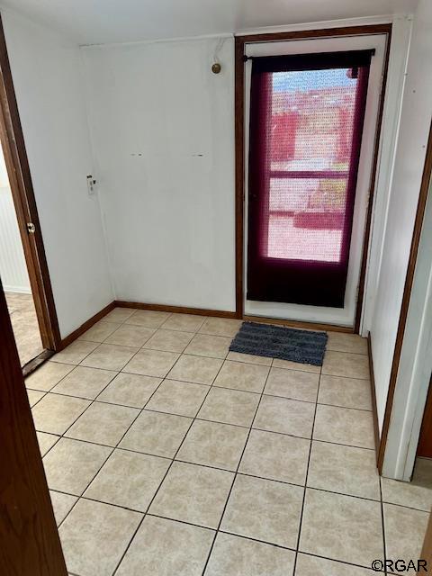 doorway with light tile patterned floors