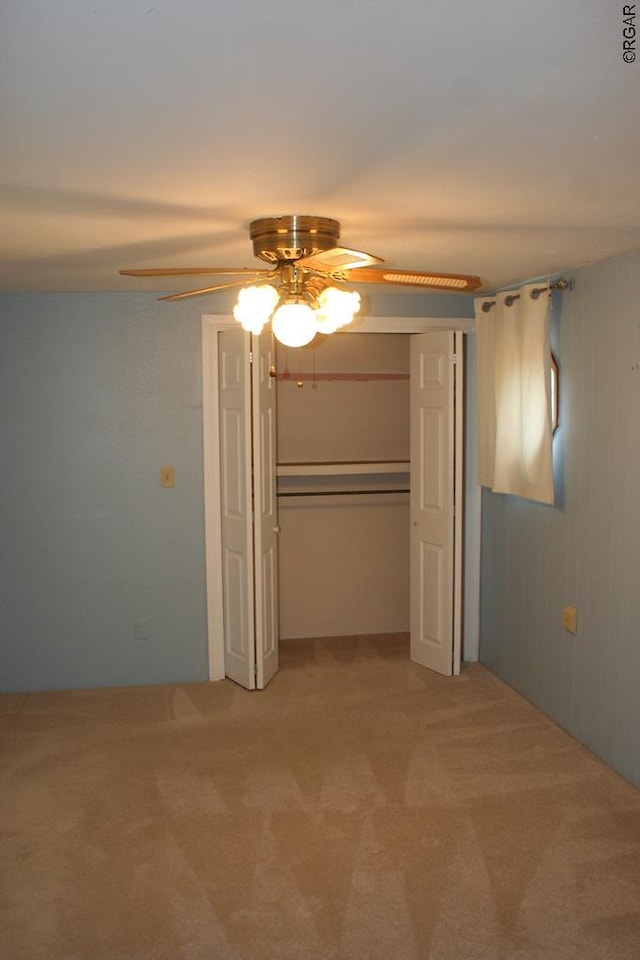 unfurnished bedroom with carpet floors, ceiling fan, and a closet