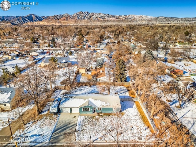 snowy aerial view featuring a mountain view