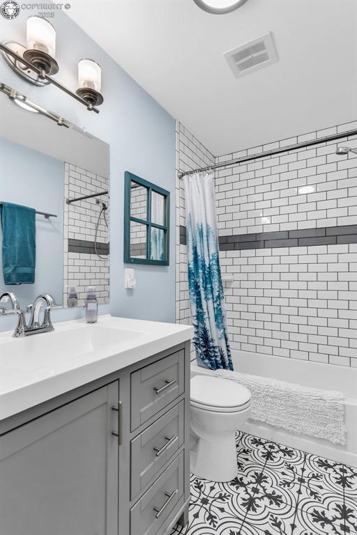 bathroom with vanity, toilet, and tile patterned flooring