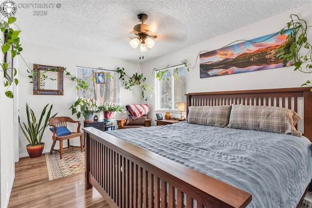 bedroom featuring light hardwood / wood-style floors and a textured ceiling