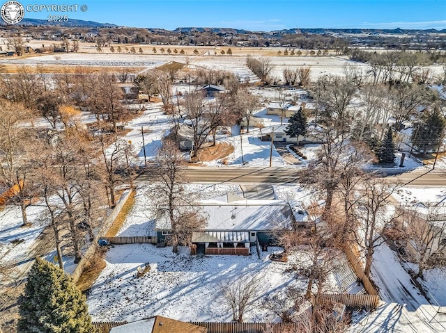 snowy aerial view featuring a mountain view