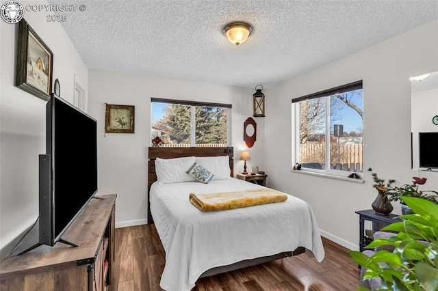 bedroom featuring dark hardwood / wood-style floors and a textured ceiling