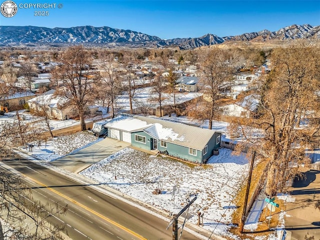 snowy aerial view featuring a mountain view