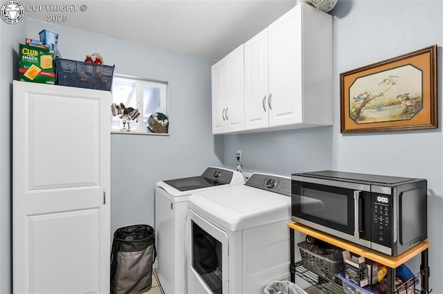 laundry area featuring separate washer and dryer and cabinets