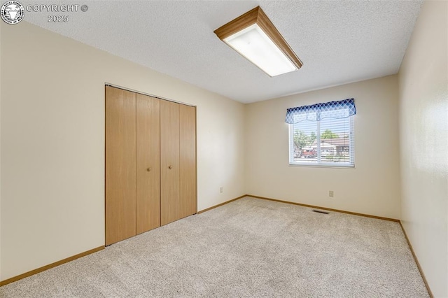 168 Willmoor Ct, Canon City, CO 81212 - unfurnished bedroom with carpet floors, a closet, and a textured ceiling