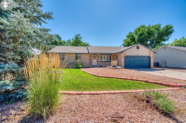 168 Willmoor Ct, Canon City, CO 81212 - ranch-style home with an attached garage, concrete driveway, brick siding, and a front yard