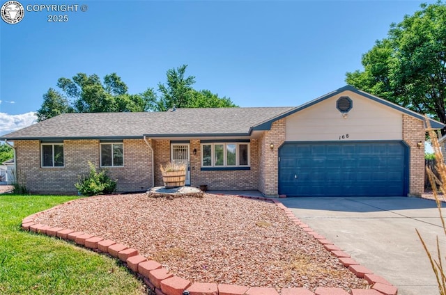 168 Willmoor Ct, Canon City, CO 81212 - single story home with concrete driveway, brick siding, a garage, and a shingled roof