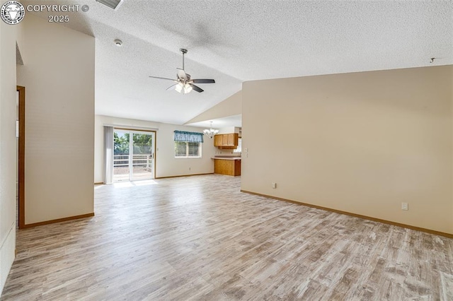 168 Willmoor Ct, Canon City, CO 81212 - unfurnished living room featuring light wood finished floors, a chandelier, ceiling fan, vaulted ceiling, and a textured ceiling