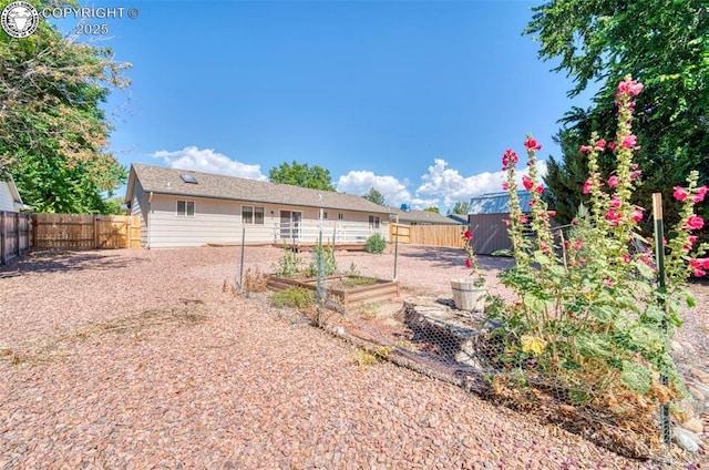 168 Willmoor Ct, Canon City, CO 81212 - back of house with a vegetable garden, a fenced backyard, and a storage shed