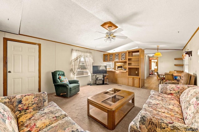 carpeted living room featuring vaulted ceiling, crown molding, ceiling fan, and a textured ceiling