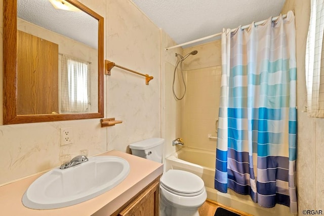 full bathroom with vanity, toilet, a textured ceiling, and shower / bath combo with shower curtain