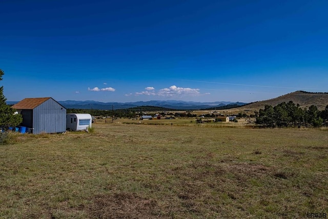 property view of mountains featuring a rural view