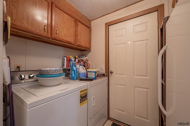 laundry room with cabinets, separate washer and dryer, and a textured ceiling