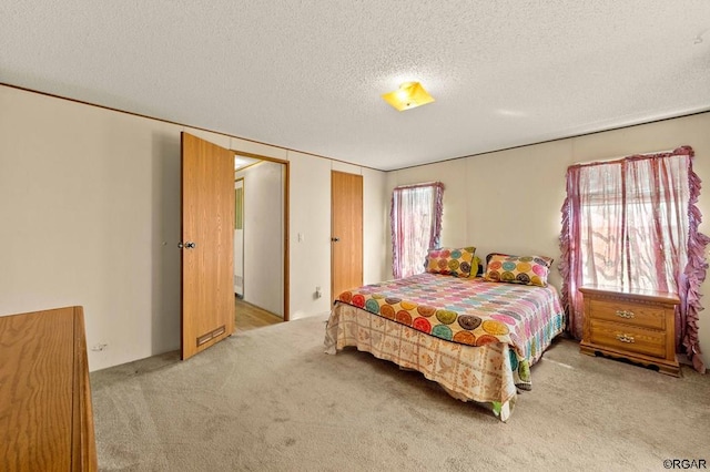 carpeted bedroom with a textured ceiling