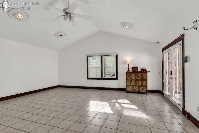 empty room with vaulted ceiling, french doors, ceiling fan, and light tile patterned flooring