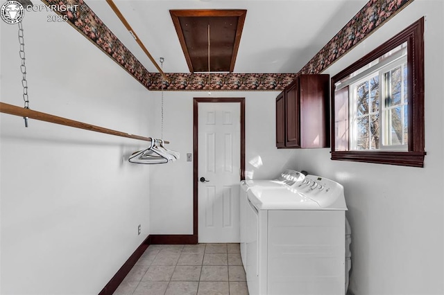 laundry area featuring washer and dryer, light tile patterned floors, and cabinets