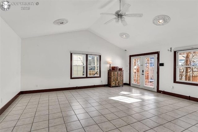 empty room featuring french doors, ceiling fan, lofted ceiling, and light tile patterned floors