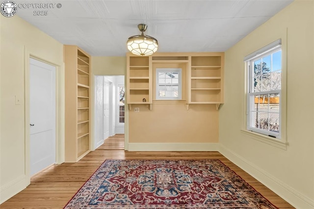 dining area featuring built in features and light wood-type flooring