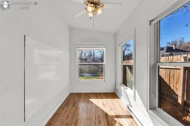 unfurnished sunroom with vaulted ceiling and ceiling fan