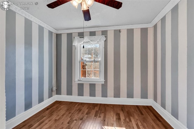 unfurnished dining area with crown molding, hardwood / wood-style floors, ceiling fan, and a textured ceiling