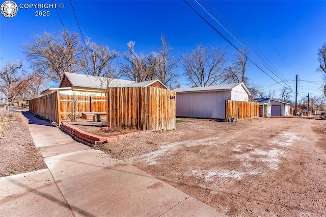 view of side of property with a garage and an outbuilding