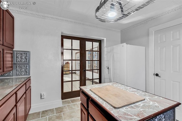 kitchen featuring white fridge with ice dispenser and french doors