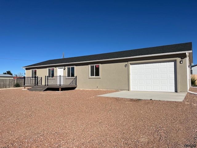 view of front of house featuring a garage and a deck