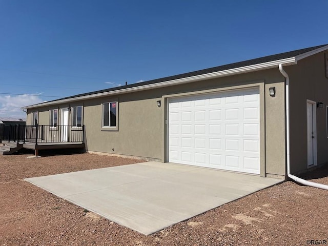 exterior space featuring a garage and a deck