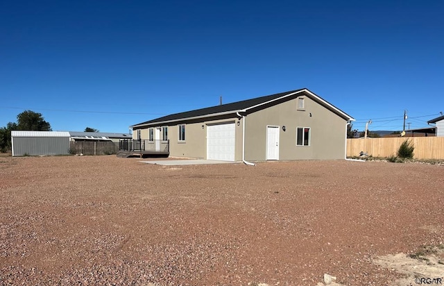 rear view of property with a garage