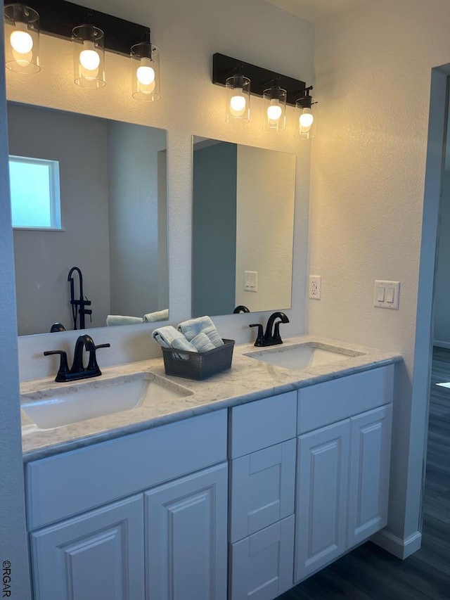 bathroom with hardwood / wood-style flooring and vanity